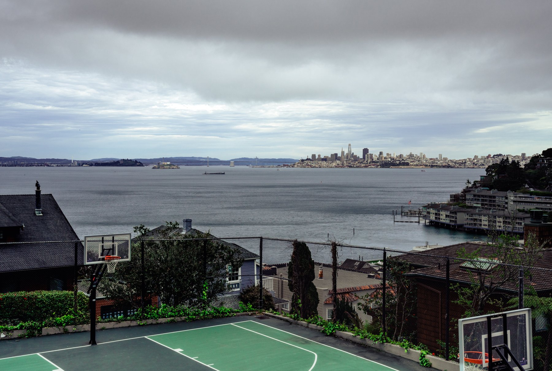 A backyard basketball court overlooking Alcatraz Island and the San Francisco skyline