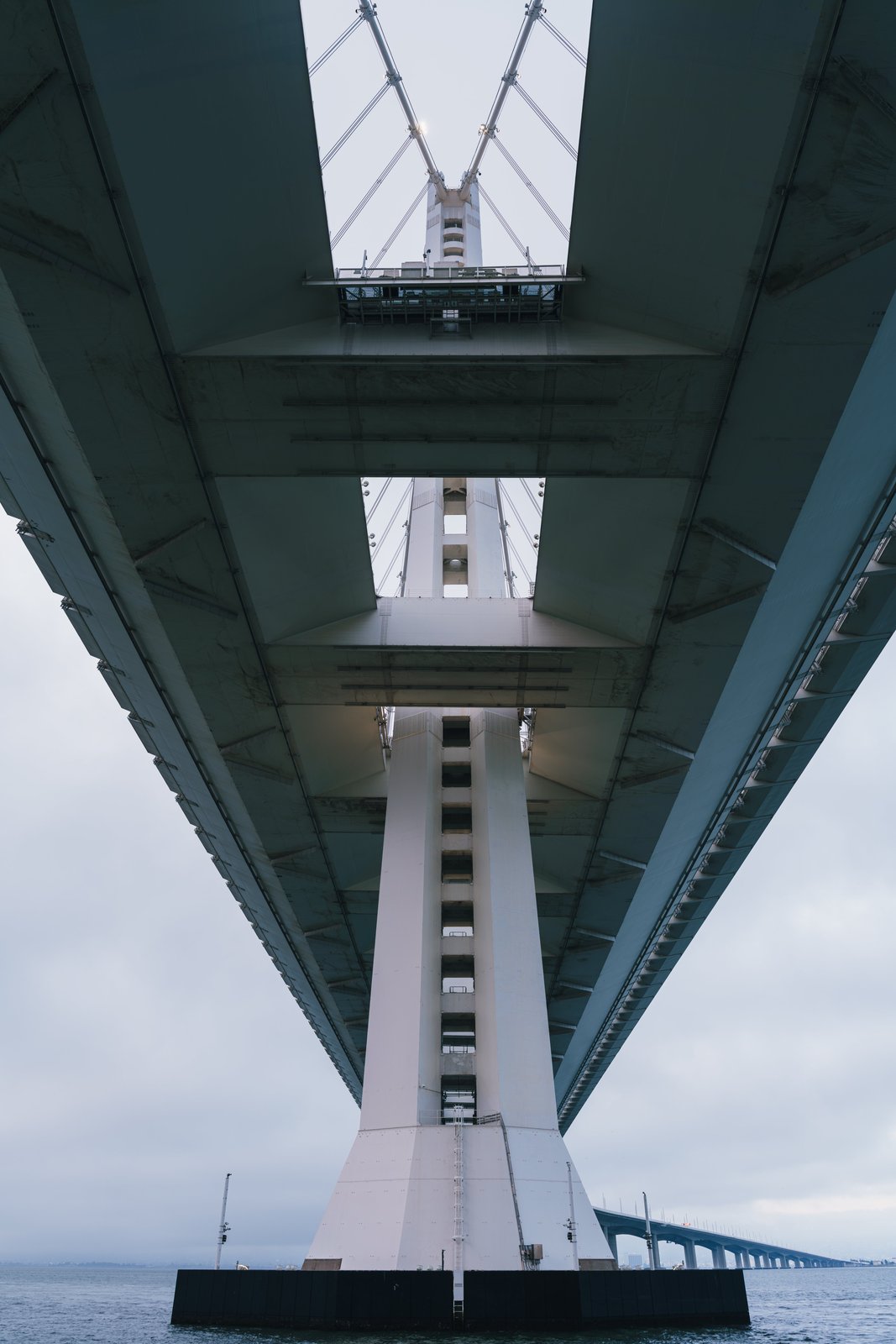 Symmetrical view looking straight up at a cable-stayed bridge tower