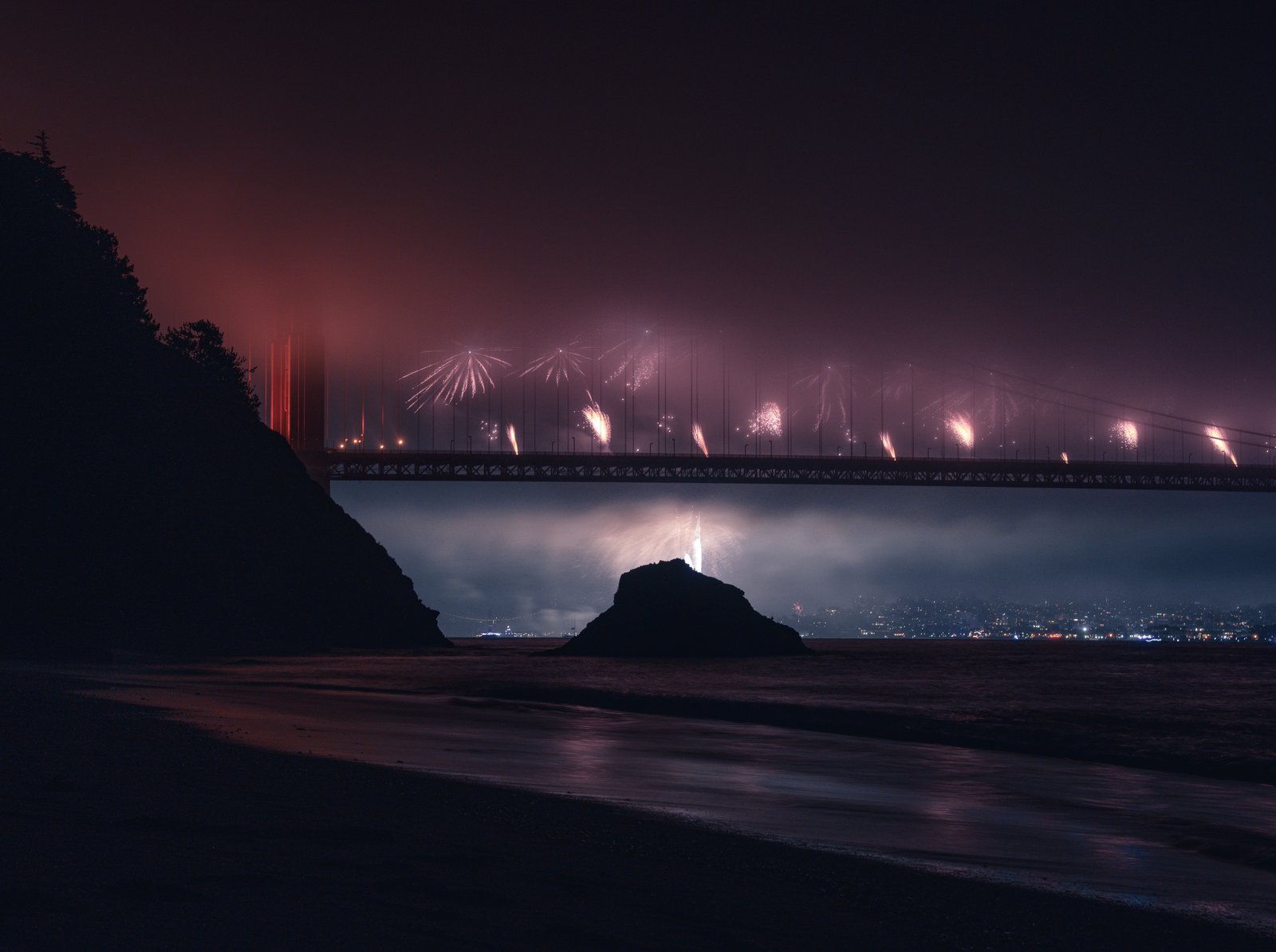 Fireworks through fog at the Golden Gate Bridge