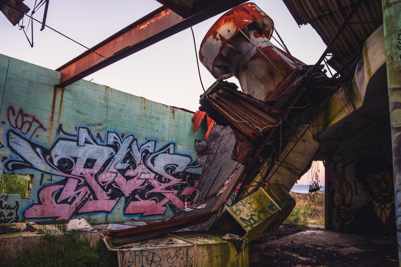Abandoned radar tower structure covered in graffiti