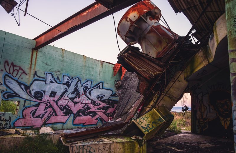 Abandoned radar tower structure covered in graffiti