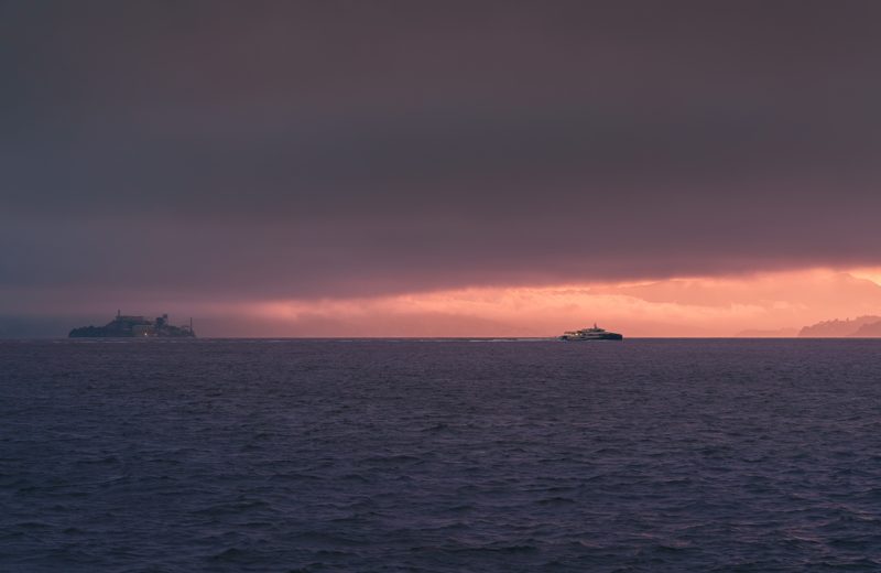 Alcatraz Island under a storm-lit horizon