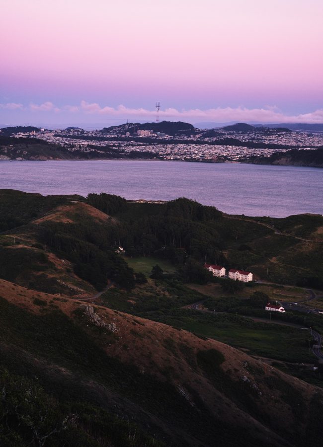 The bay and Marin hillside at dusk with a historic building below