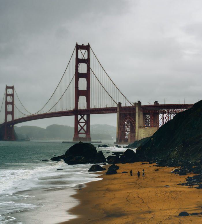 Golden Gate Bridge from Baker Beach under a dramatic stormy sky