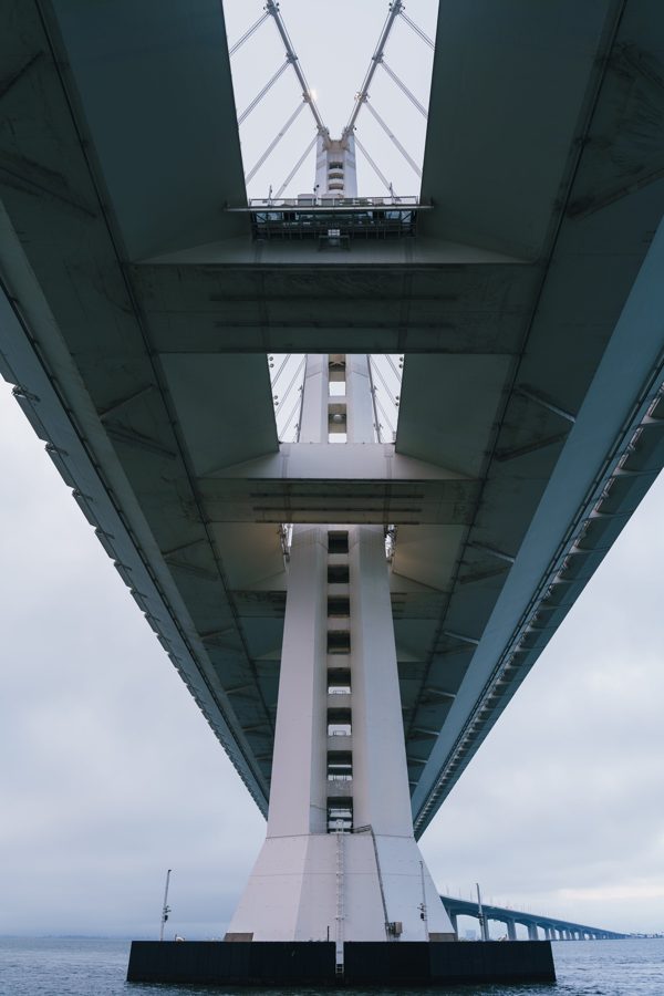 Symmetrical view looking straight up at a cable-stayed bridge tower